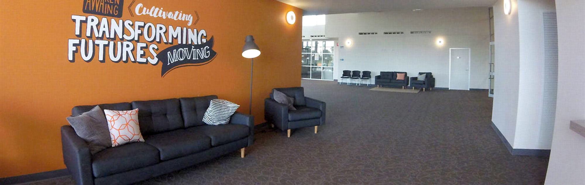 Large comfy couches with cozy cushions line the walls of the church foyer.