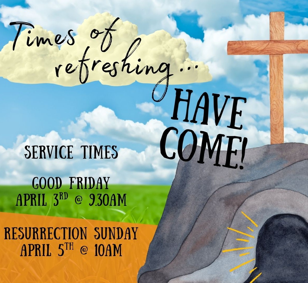 Two women standing together in the entry foyer of a church smiling at each other, having a friendly conversation.